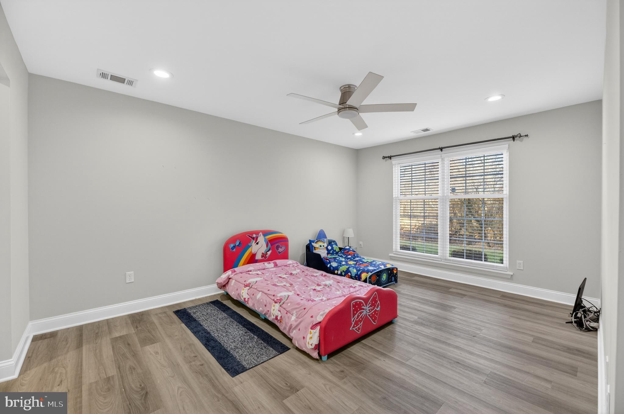 133 Andover Place Robbinsville, NJ 08691 - Photo 18 of 20 a bedroom with a bed and wooden floor