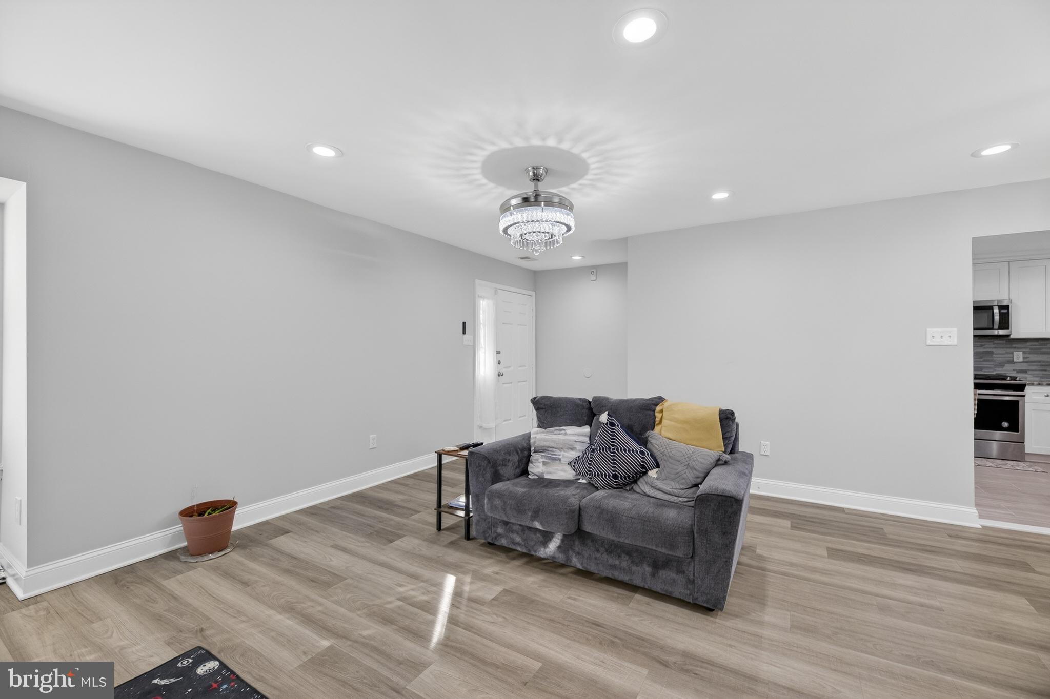 133 Andover Place Robbinsville, NJ 08691 - Photo 7 of 20 a living room with furniture and a chandelier