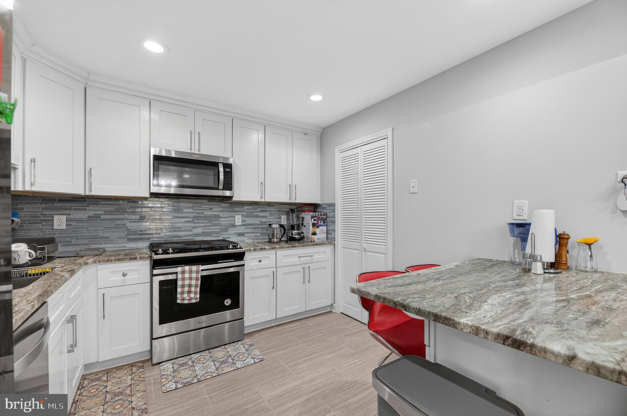 133 Andover Place Robbinsville, NJ 08691 - Photo 10 of 20 a kitchen with kitchen island granite countertop a stove sink and microwave