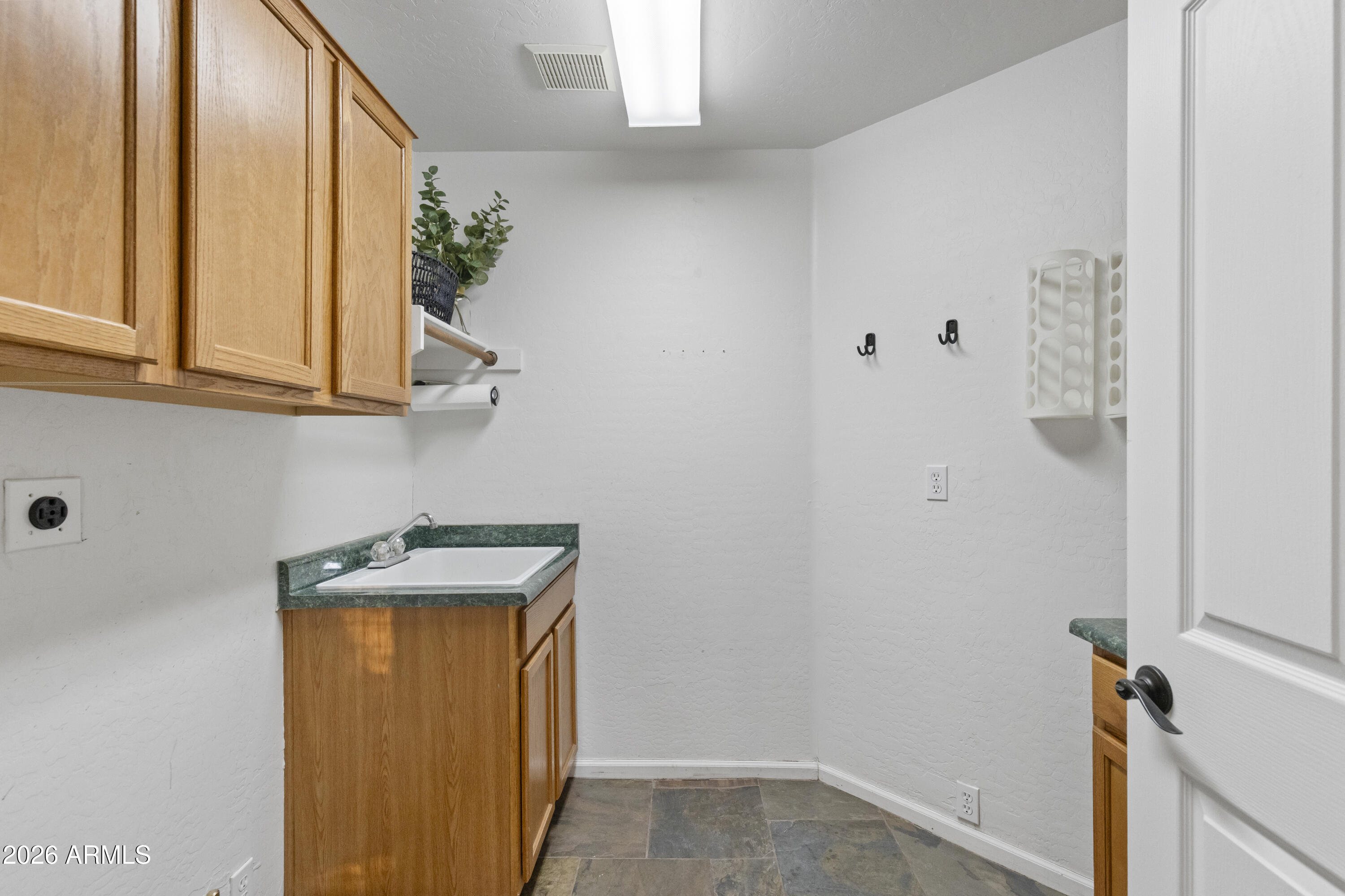 2519 East Rawhide Street Gilbert, AZ 85296 - Photo 13 of 35 a bathroom with a sink a mirror and a window
