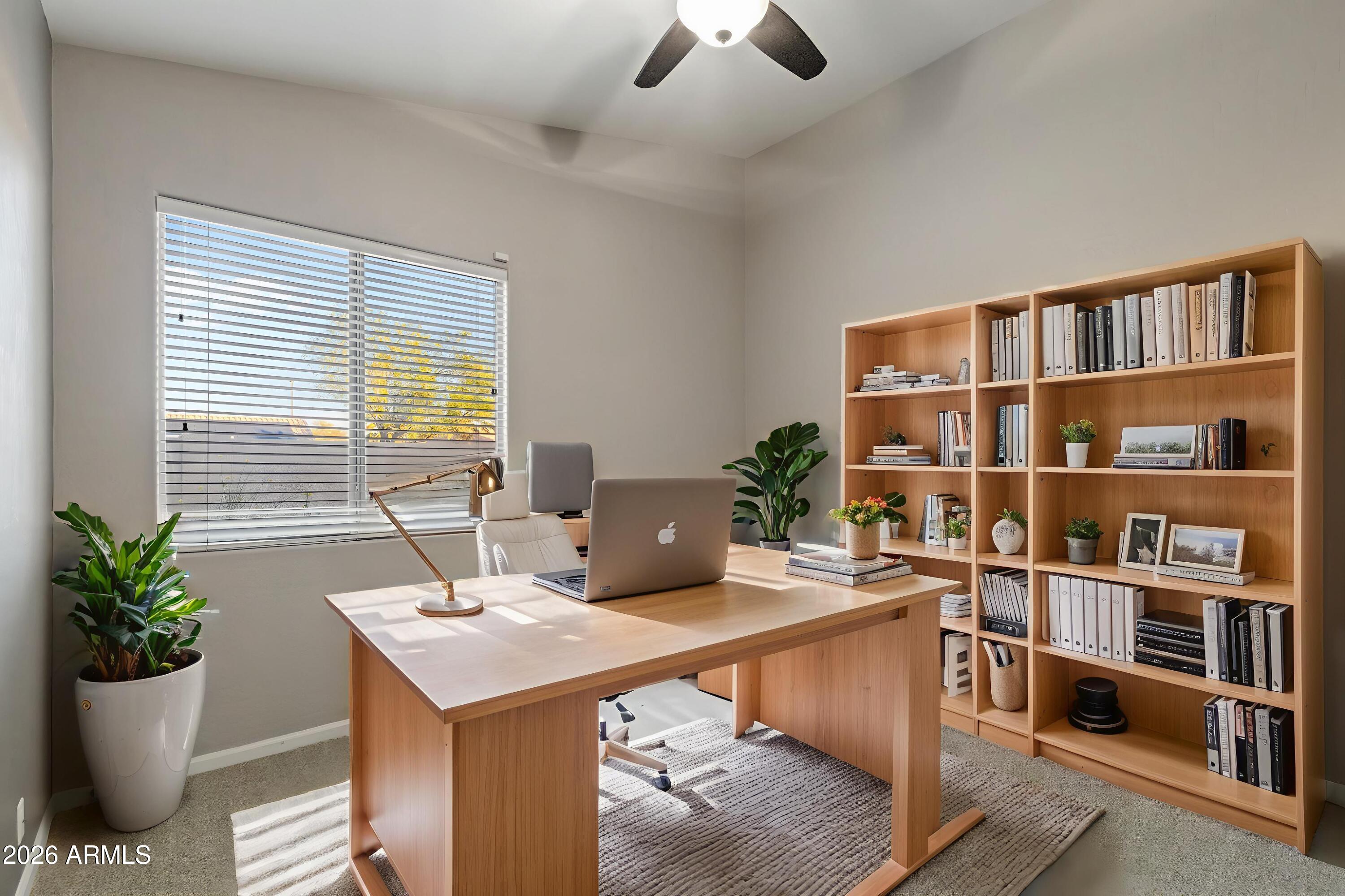 2519 East Rawhide Street Gilbert, AZ 85296 - Photo 14 of 35 a view of a workspace with furniture and a potted plant