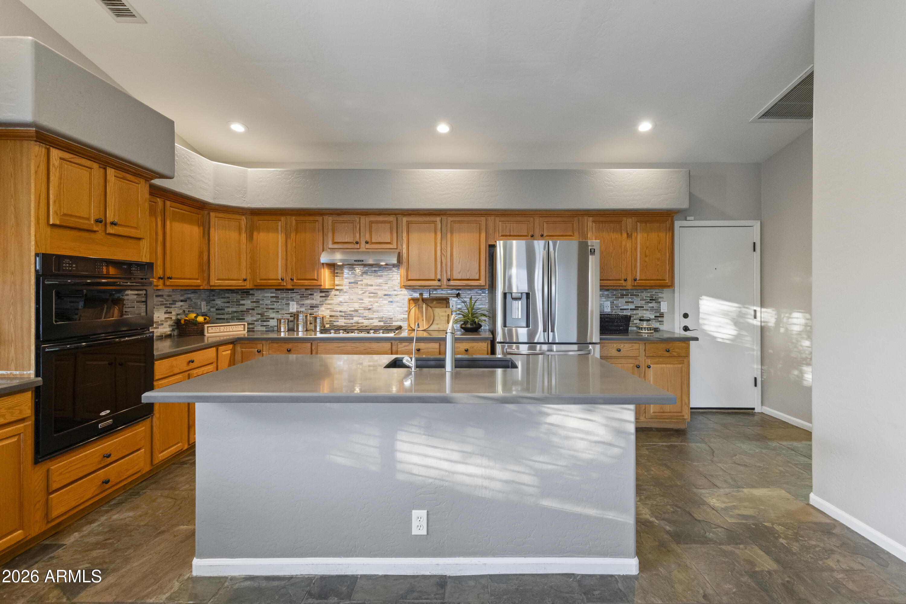 2519 East Rawhide Street Gilbert, AZ 85296 - Photo 3 of 35 a large kitchen with stainless steel appliances a large counter top