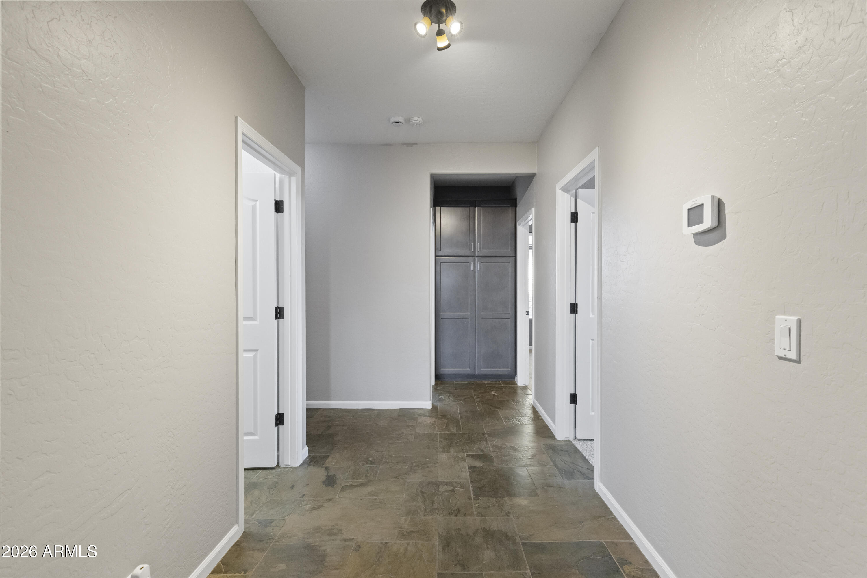 2519 East Rawhide Street Gilbert, AZ 85296 - Photo 6 of 35 a view of a hallway with wooden shelves