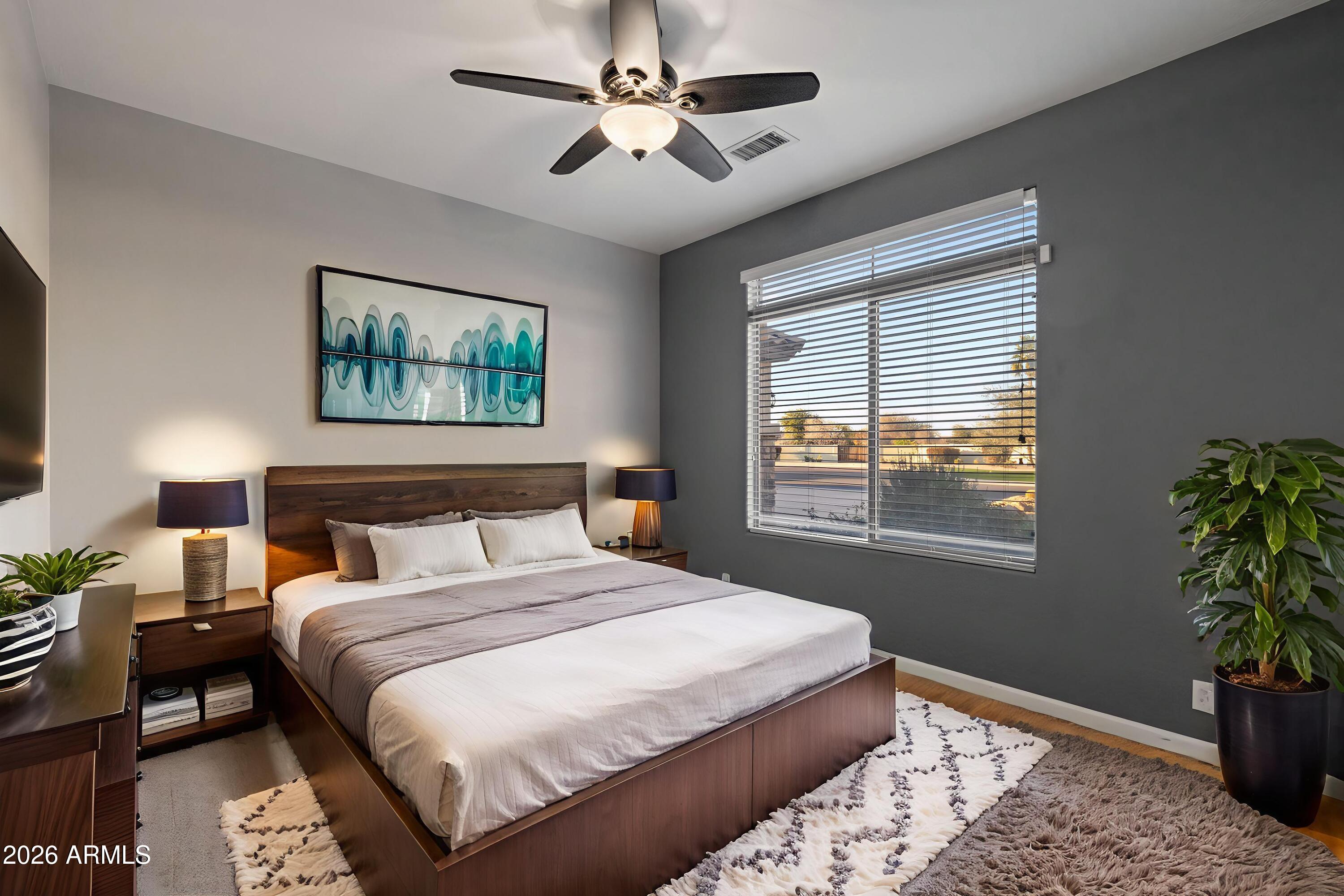 2519 East Rawhide Street Gilbert, AZ 85296 - Photo 10 of 35 a bedroom with bed a chandelier and a potted plant