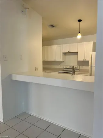 a kitchen with a sink cabinets and window