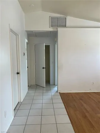 a view of a livingroom with an empty space and a window