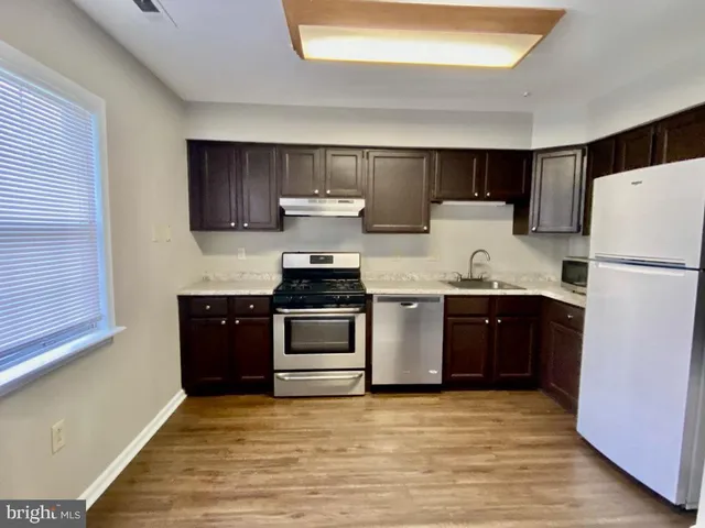 a kitchen with a refrigerator and a stove