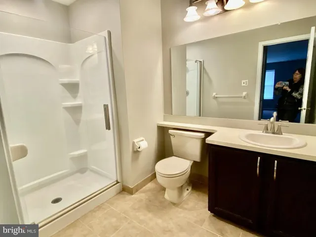 a bathroom with a sink toilet a mirror and shower