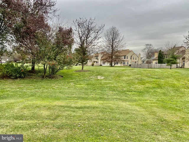 a view of field with trees in the background