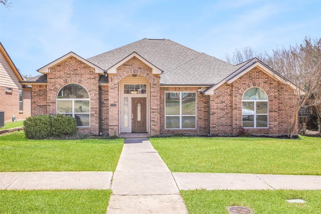 2124 Fawn Ridge Trail Carrollton, TX 75010 - Photo 1 of 1 a front view of a house with a yard and garage