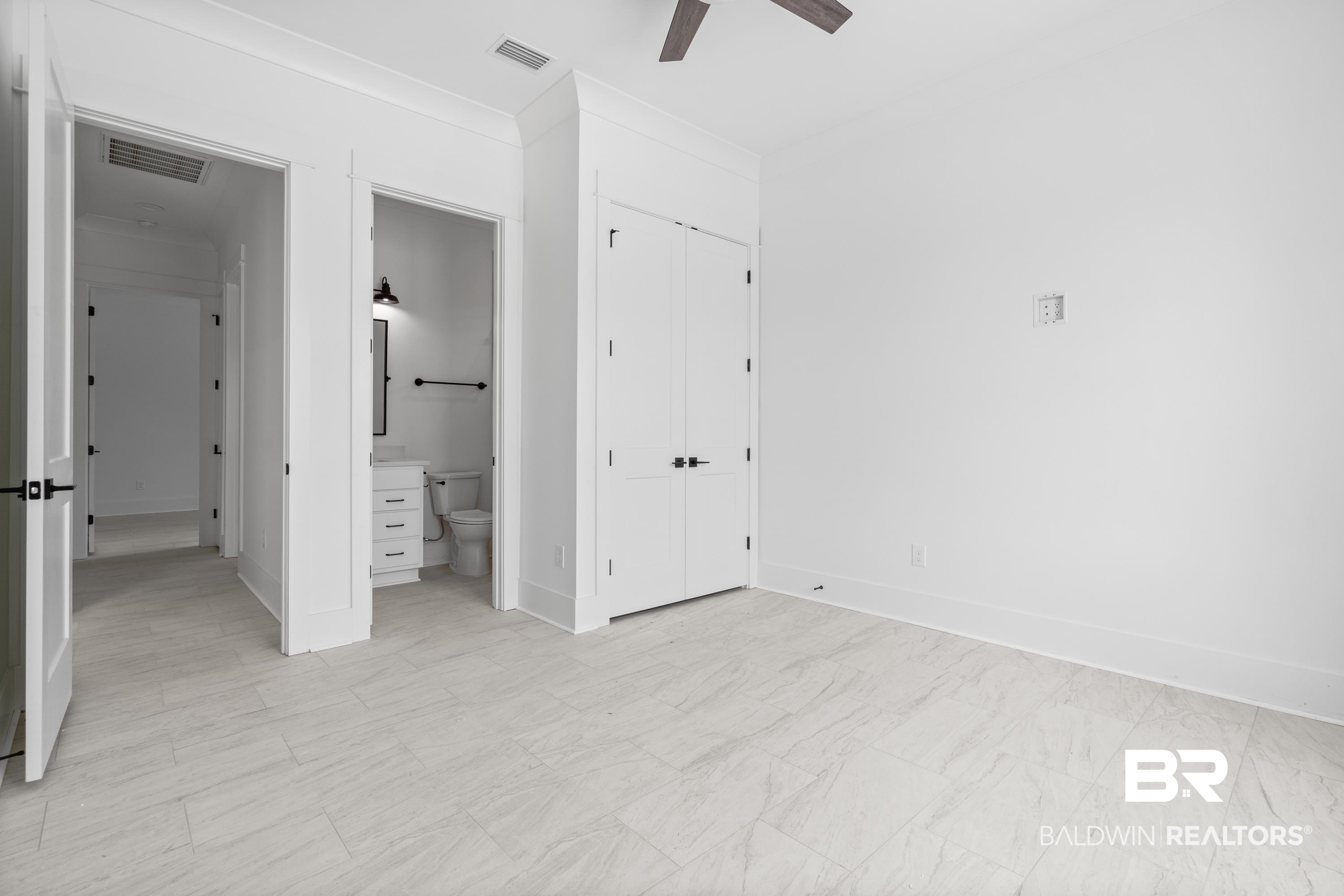 30650 Ono N Loop West Orange Beach, AL 36561 - Photo 22 of 38 Unfurnished bedroom featuring connected bathroom, crown molding, baseboards, and ceiling fan