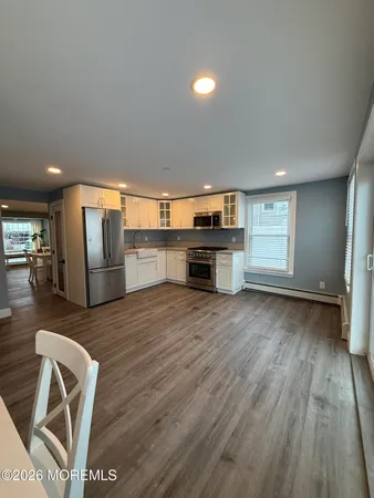 a view of kitchen with furniture and wooden floor