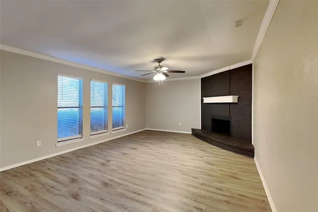 wooden floor in an empty room with a fireplace