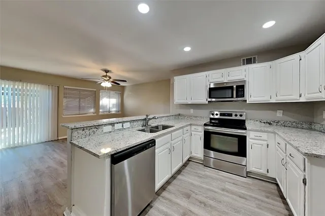 a kitchen with a sink stove and microwave