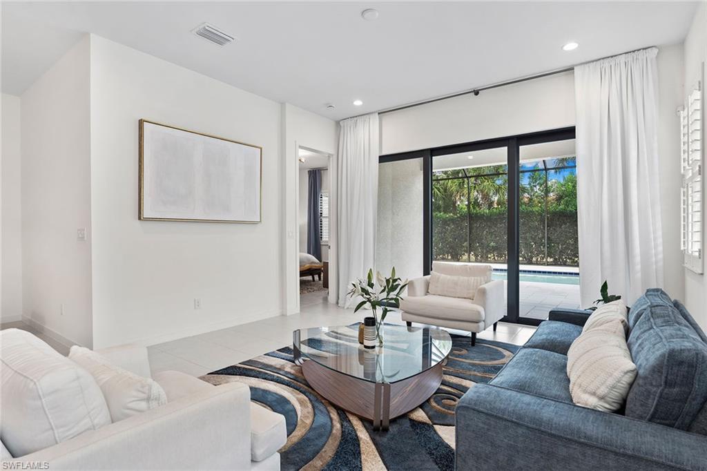 14875 Loggerhead Drive Naples, FL 34120 - Photo 12 of 28 a living room with furniture and a large window
