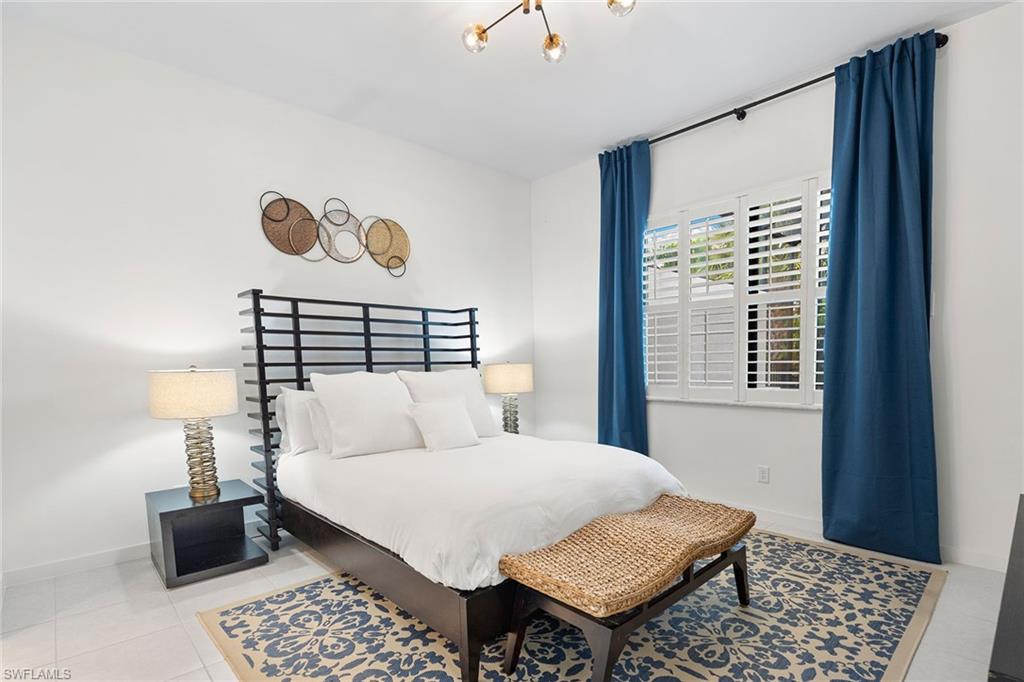 14875 Loggerhead Drive Naples, FL 34120 - Photo 13 of 28 a bedroom with a bed and a window with a rug