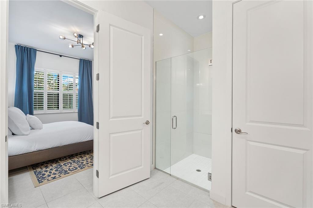 14875 Loggerhead Drive Naples, FL 34120 - Photo 15 of 28 a bathroom with a tub shower and sink