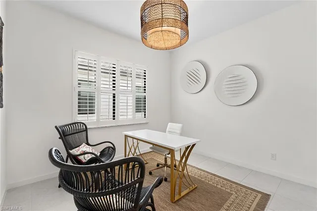 a view of a dining room with furniture and chandelier