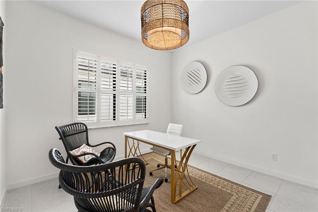 14875 Loggerhead Drive Naples, FL 34120 - Photo 16 of 28 a view of a dining room with furniture and chandelier