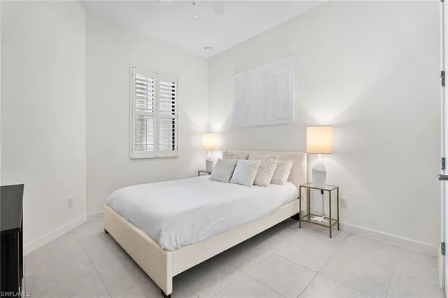 a bedroom with a bed and a lamp