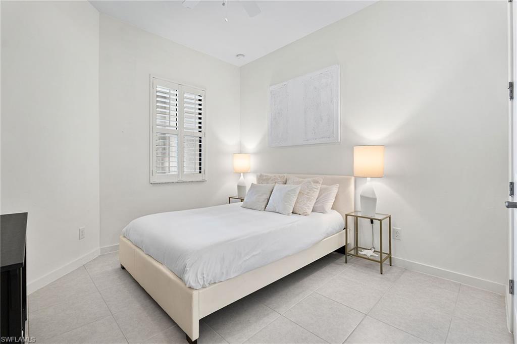 14875 Loggerhead Drive Naples, FL 34120 - Photo 17 of 28 a bedroom with a bed and a lamp