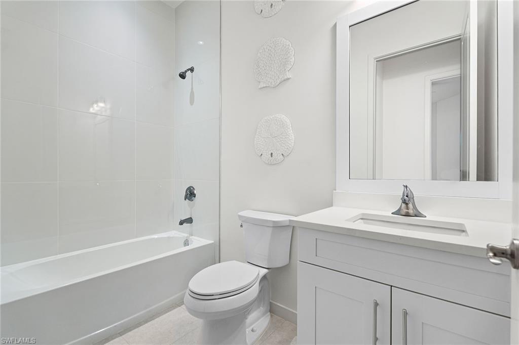 14875 Loggerhead Drive Naples, FL 34120 - Photo 18 of 28 a bathroom with a sink a toilet and shower