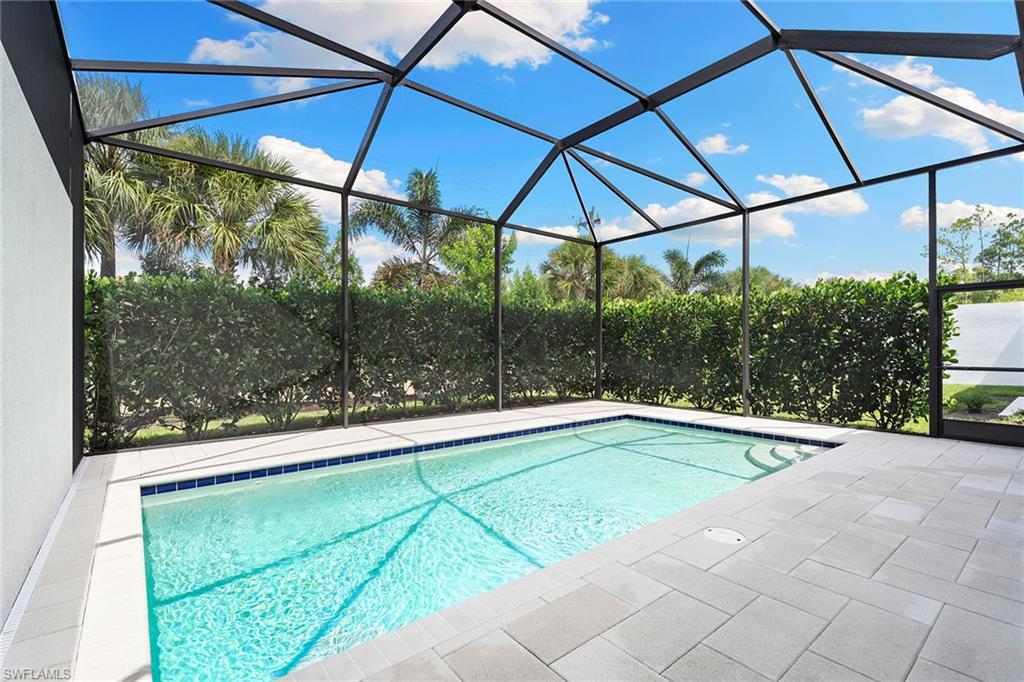 14875 Loggerhead Drive Naples, FL 34120 - Photo 19 of 28 a view of a swimming pool with a yard