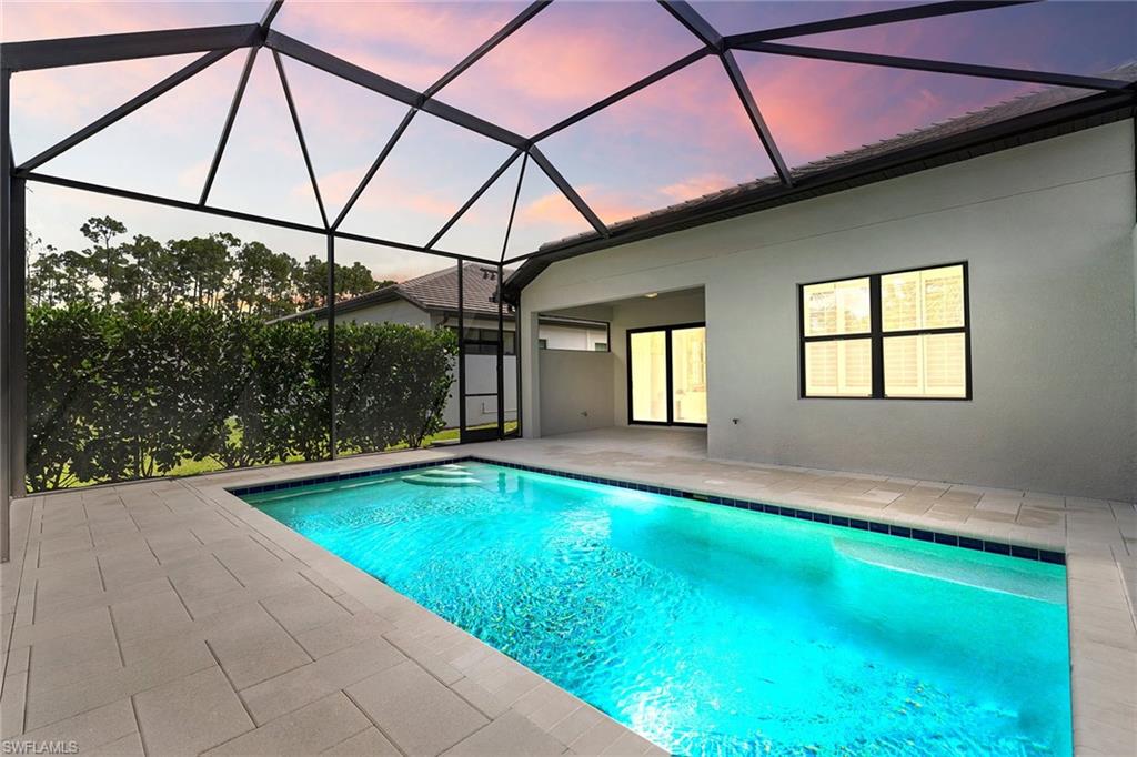 14875 Loggerhead Drive Naples, FL 34120 - Photo 2 of 28 a view of swimming pool with a yard