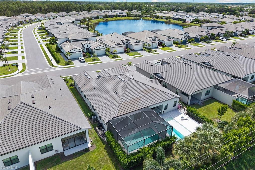 14875 Loggerhead Drive Naples, FL 34120 - Photo 26 of 28 an aerial view of a house with a garden and lake view