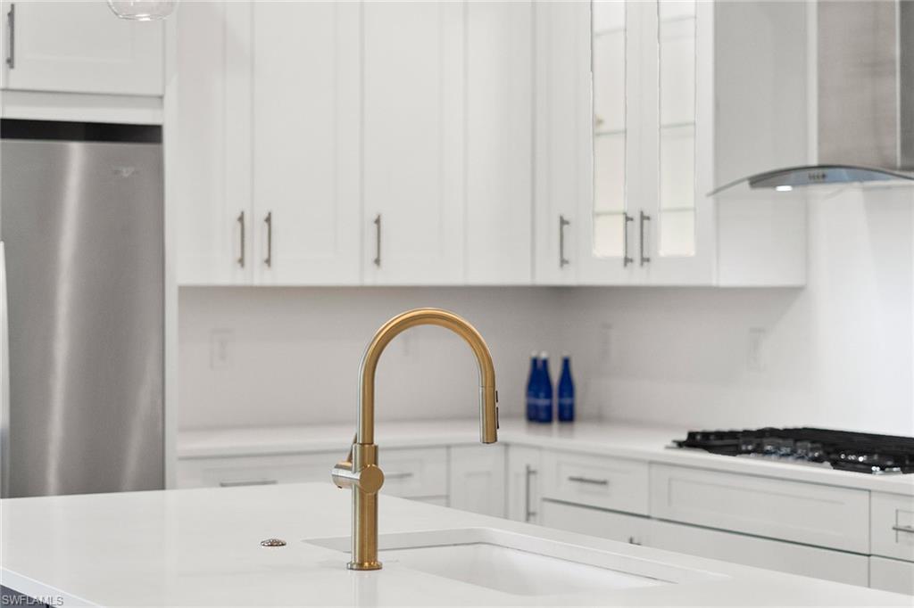 14875 Loggerhead Drive Naples, FL 34120 - Photo 4 of 28 a close view of a sink a stove and cabinets