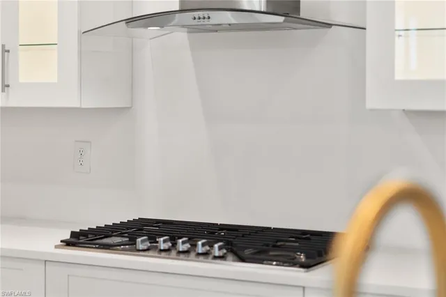 a close up of a sink a stove and a window