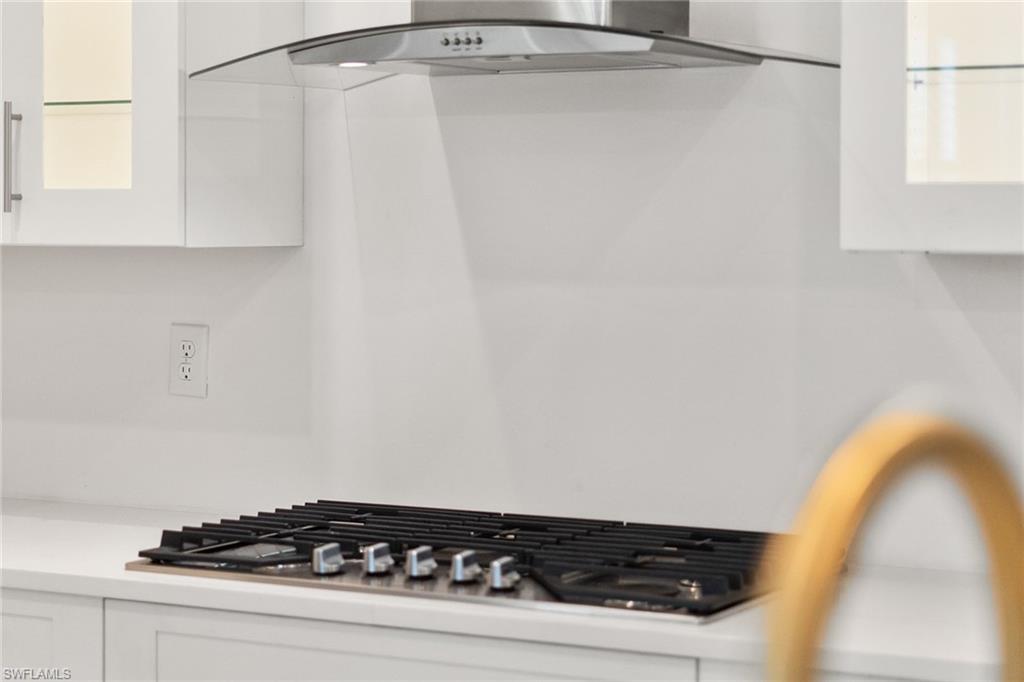 14875 Loggerhead Drive Naples, FL 34120 - Photo 5 of 28 a close up of a sink a stove and a window