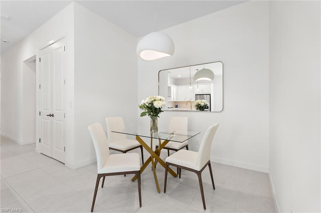 14875 Loggerhead Drive Naples, FL 34120 - Photo 8 of 28 a dining room with furniture and wooden floor