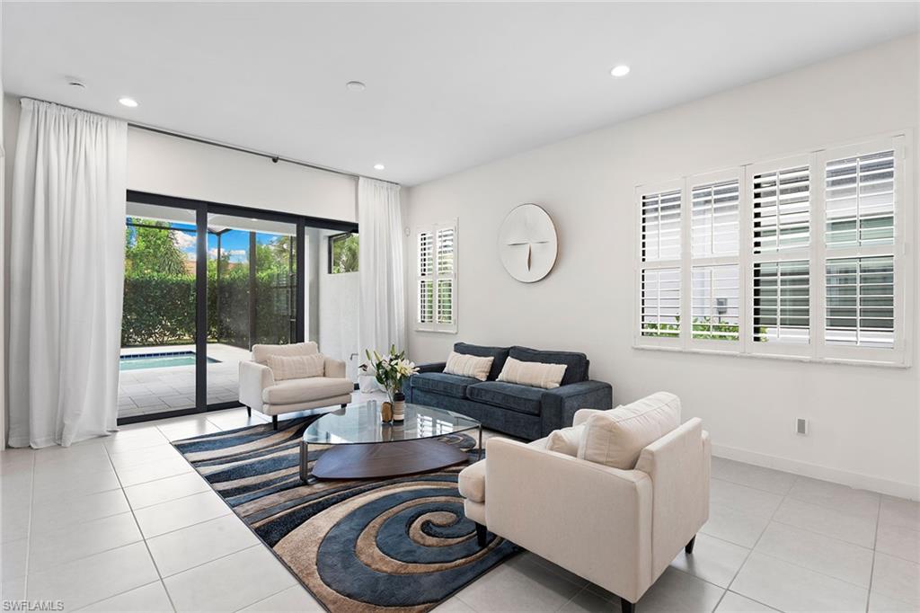 14875 Loggerhead Drive Naples, FL 34120 - Photo 10 of 28 a living room with furniture and a large window