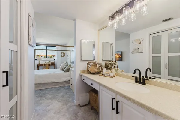 a bathroom with double vanity and a mirror