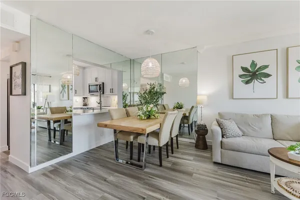a view of a dining room with furniture and wooden floor