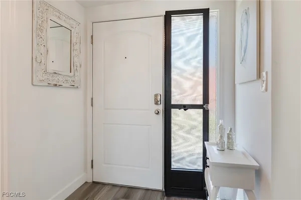 a view of front door with wooden floor
