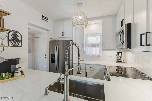 a kitchen with a refrigerator and a sink