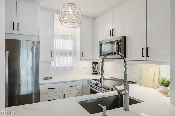 a kitchen with a refrigerator stove and a sink