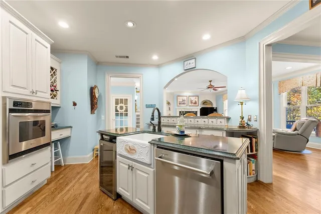 a kitchen with a stove and a wooden floors