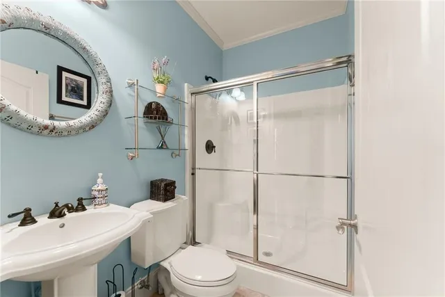 a white toilet sitting next to a bathroom sink