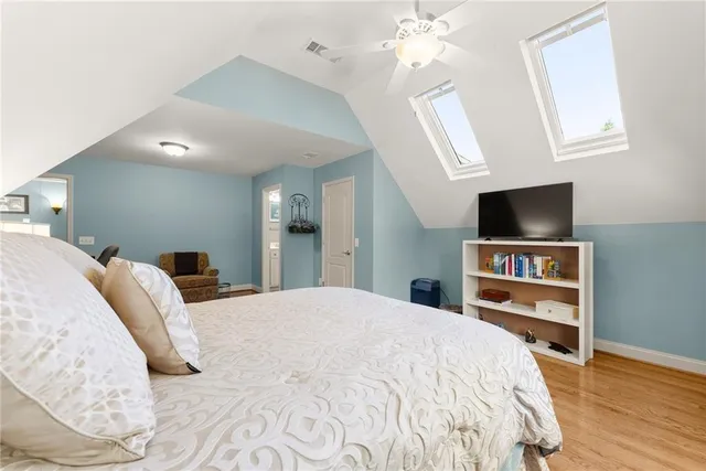 a bathroom with a sink a toilet a mirror and shower curtain