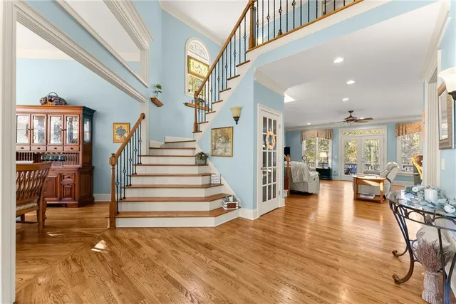 a view of entryway and hall with wooden floor
