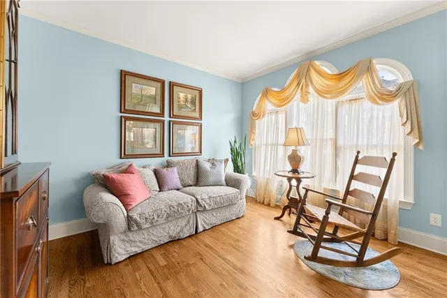 a living room with furniture and a floor to ceiling window