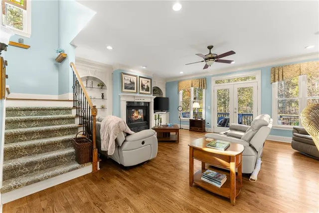 a living room with fireplace furniture and a large window