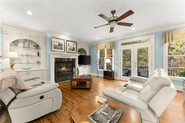 a living room with furniture ceiling fan and a fireplace