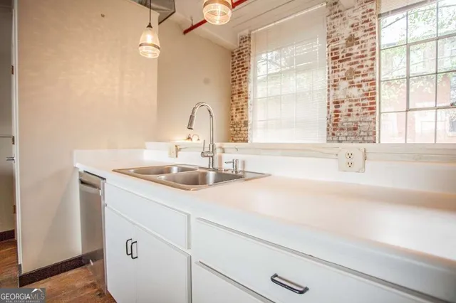 a kitchen with stainless steel appliances a stove a refrigerator and a microwave