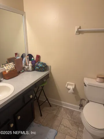 a bathroom with a sink a toilet and a mirror