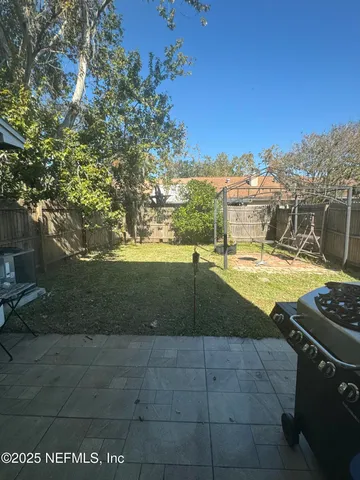 a view of a swimming pool with an outdoor seating and a yard