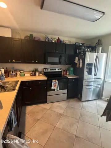 a kitchen with stainless steel appliances granite countertop a stove a refrigerator and a sink